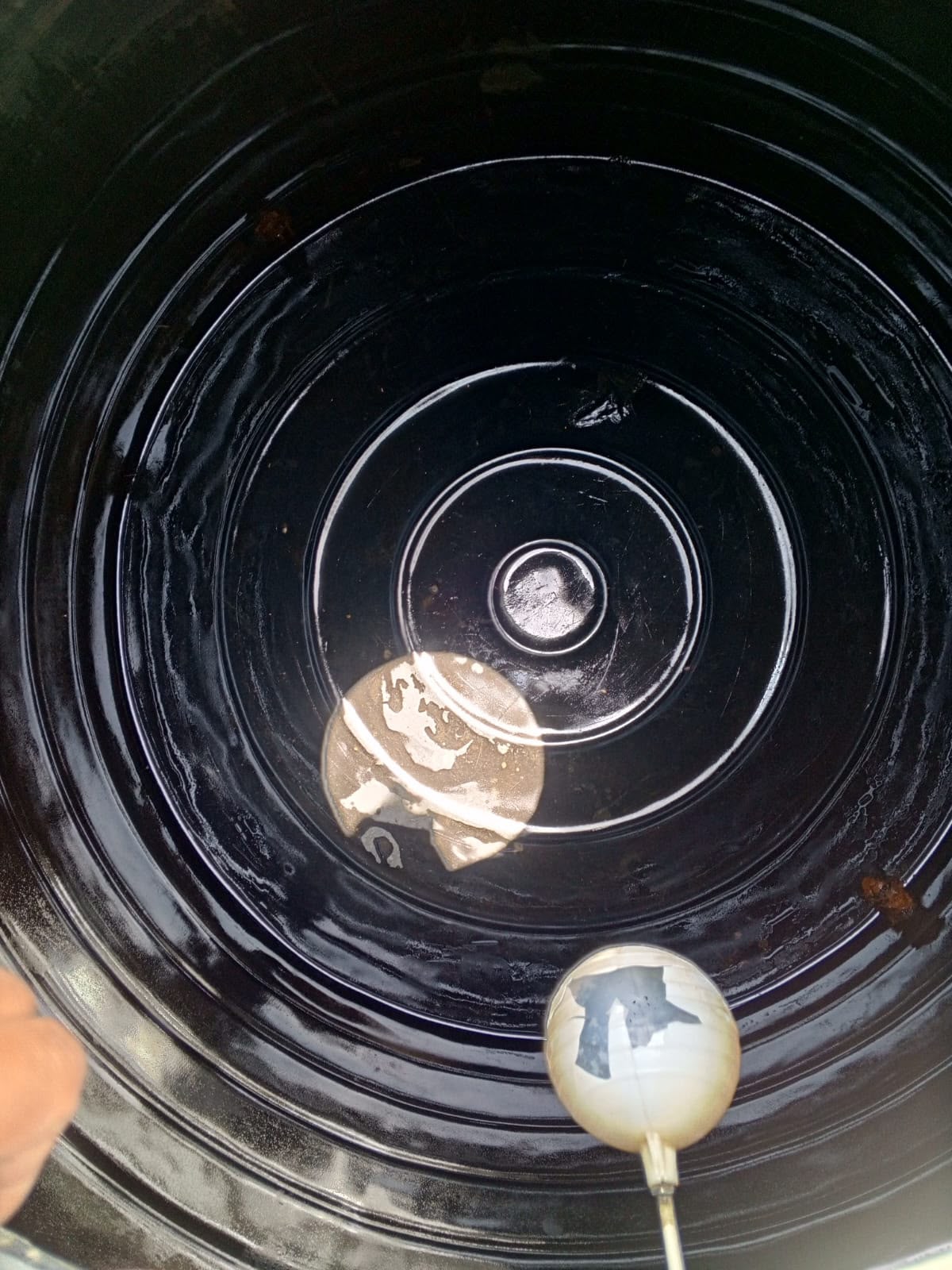 Plastic water tank interior showing accumulated deposits