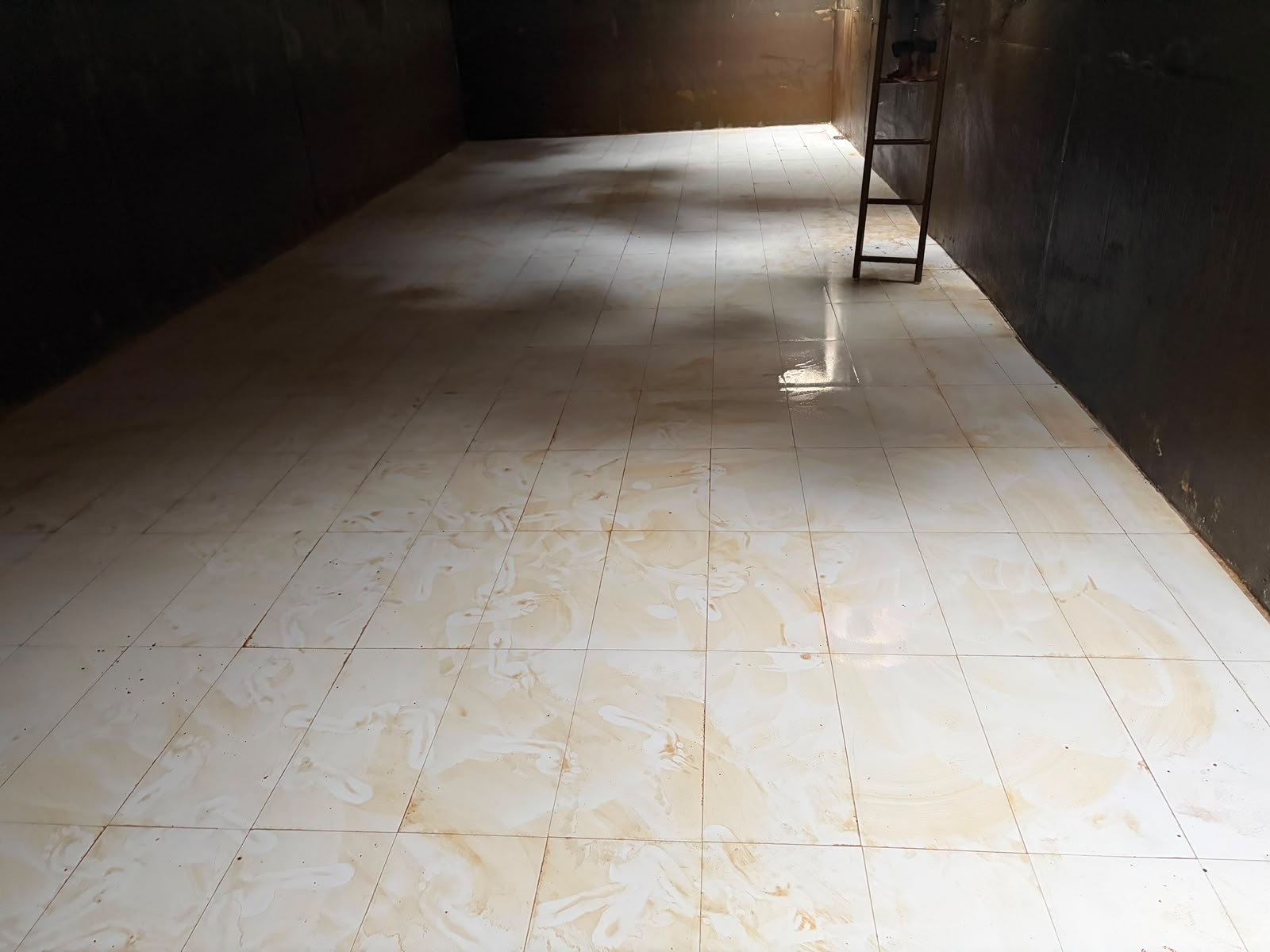 Clean large tiled water storage tank interior